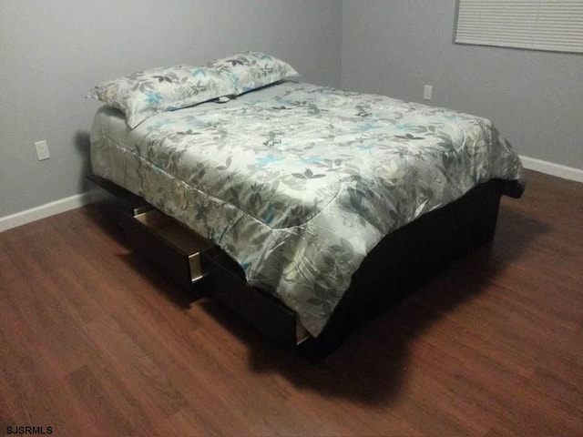 bedroom featuring dark wood-type flooring