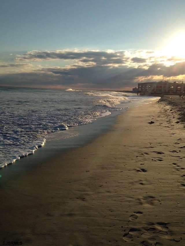 property view of water featuring a beach view