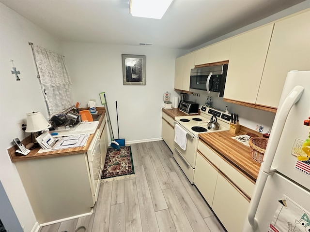 kitchen with cream cabinets, white appliances, visible vents, baseboards, and light wood finished floors