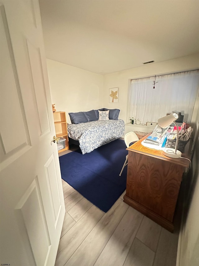 bedroom featuring visible vents and light wood finished floors