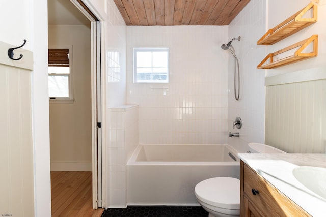 full bathroom with tiled shower / bath combo, vanity, plenty of natural light, and toilet