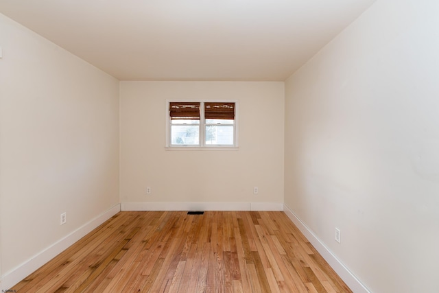 unfurnished room with light hardwood / wood-style flooring