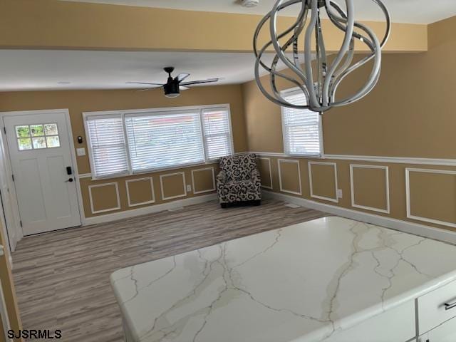 sitting room featuring ceiling fan and light wood-type flooring