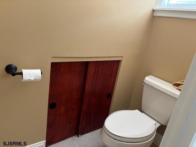 bathroom with tile patterned floors and toilet