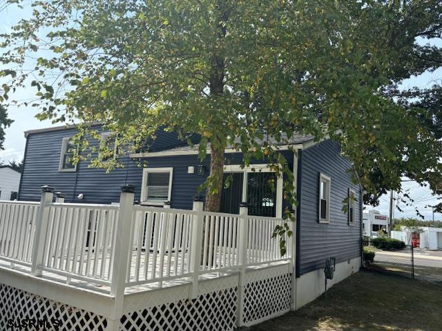 rear view of house with a wooden deck