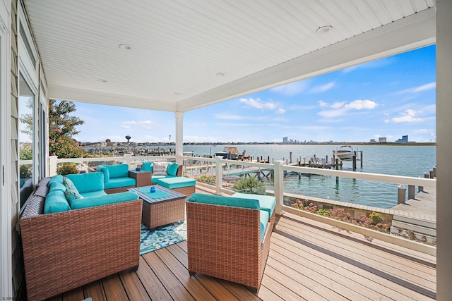 wooden deck with an outdoor hangout area and a water view