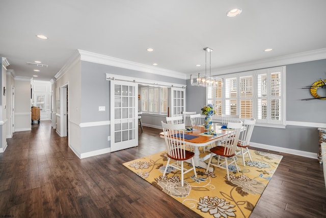 dining space featuring crown molding, dark hardwood / wood-style floors, and a barn door