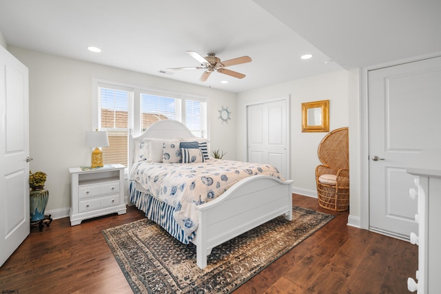 bedroom with ceiling fan, dark hardwood / wood-style flooring, and a closet