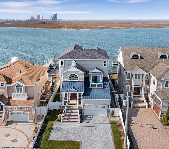 view of front of property featuring a garage and a water view