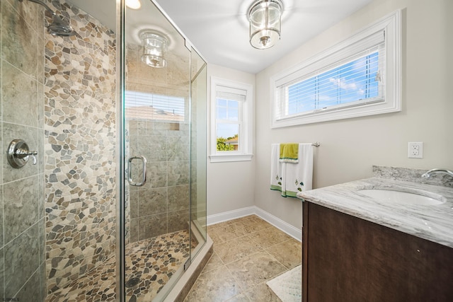 bathroom featuring an enclosed shower, vanity, and tile patterned flooring