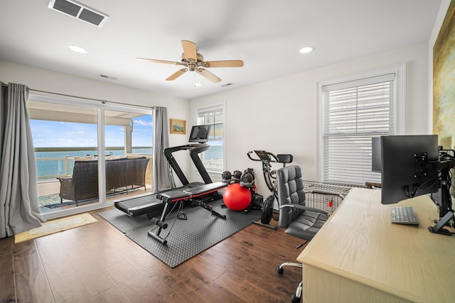 interior space featuring a water view, ceiling fan, and hardwood / wood-style flooring