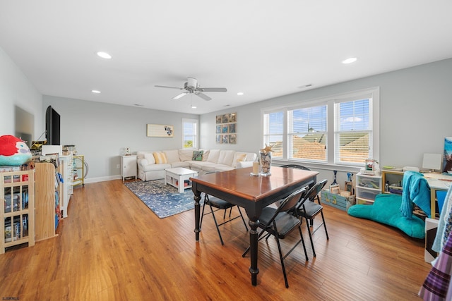 dining room with ceiling fan and light wood-type flooring