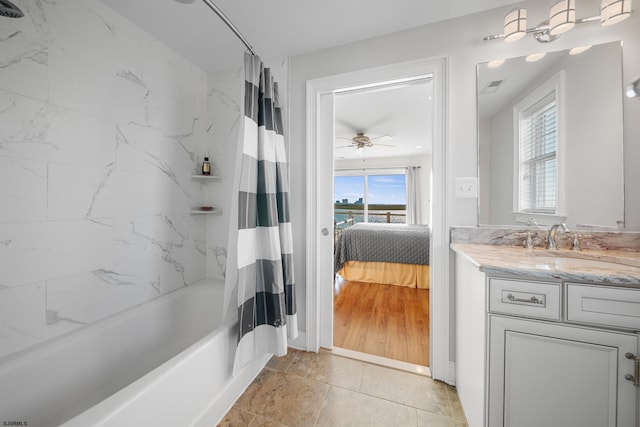 bathroom with shower / tub combo, vanity, plenty of natural light, and ceiling fan