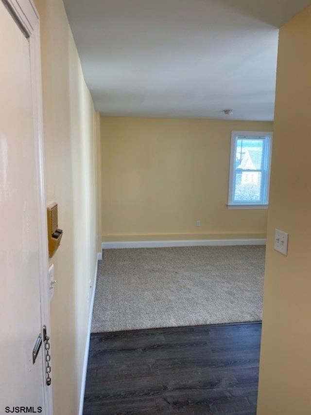 spare room with dark hardwood / wood-style flooring