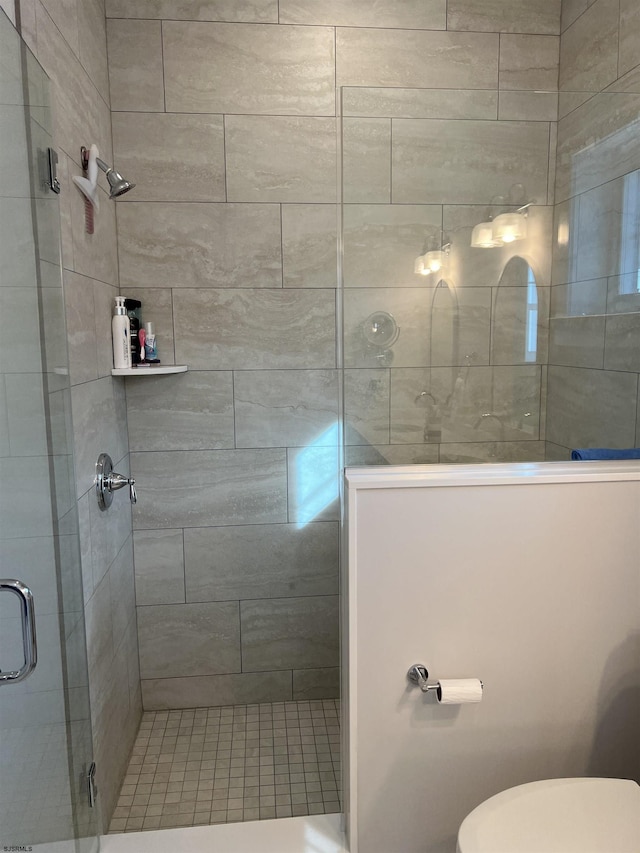 bathroom with toilet and walk in shower