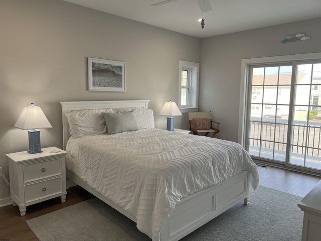 bedroom featuring dark hardwood / wood-style floors and access to outside