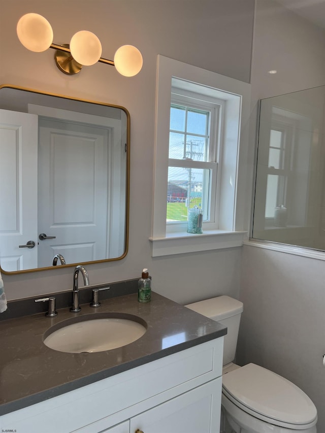 bathroom featuring vanity and toilet