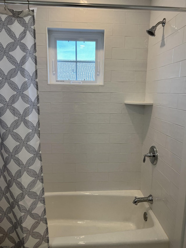 bathroom with shower / bathtub combination with curtain