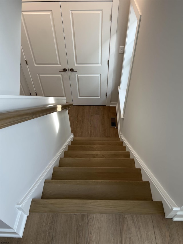 stairway featuring hardwood / wood-style floors