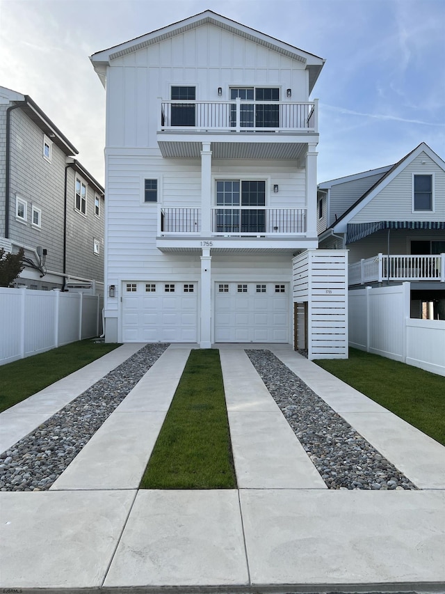 view of front of property featuring a garage and a balcony