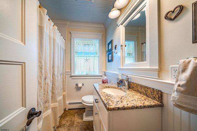 bathroom featuring a baseboard radiator, vanity, crown molding, and toilet