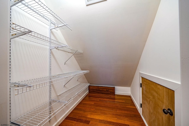 walk in closet featuring dark wood-type flooring