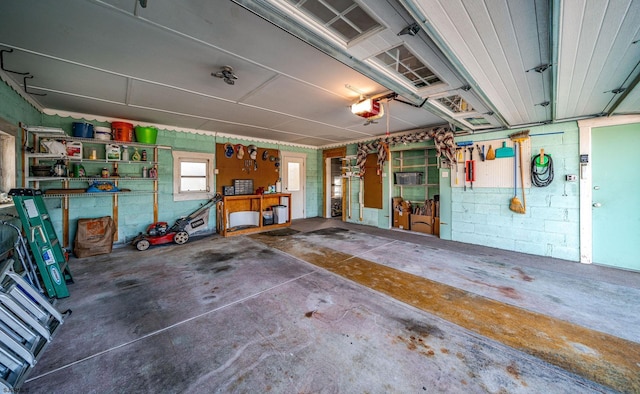 garage with a garage door opener and a workshop area