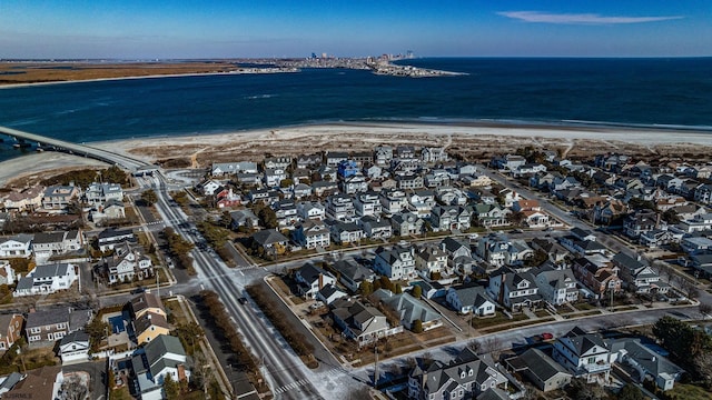 birds eye view of property with a water view and a view of the beach