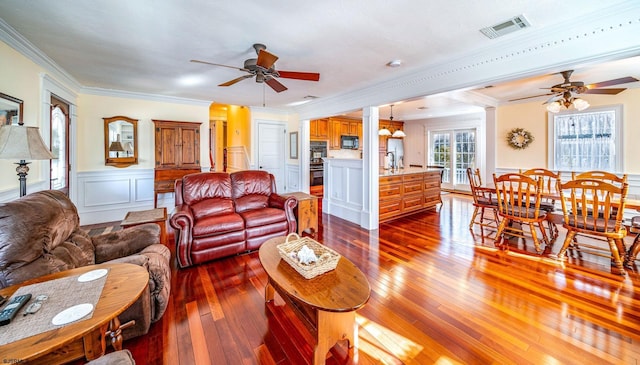 living room featuring sink, hardwood / wood-style flooring, ornamental molding, and ceiling fan