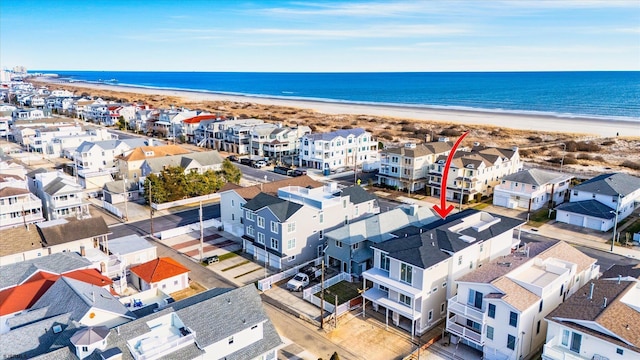 aerial view with a water view and a beach view