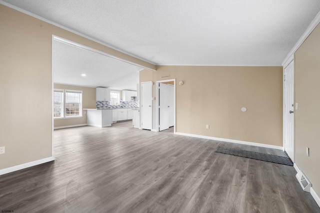 unfurnished living room with hardwood / wood-style flooring, vaulted ceiling, and a textured ceiling