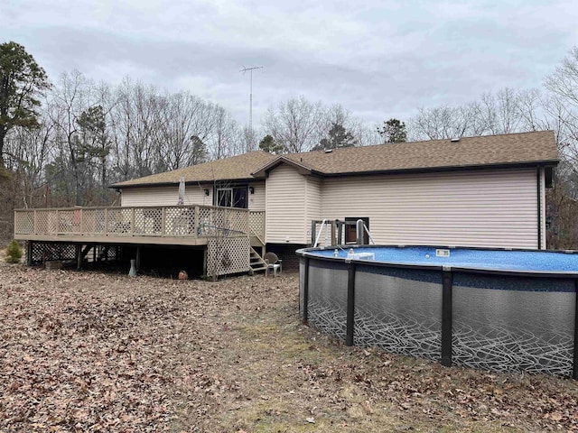 rear view of house with a swimming pool side deck