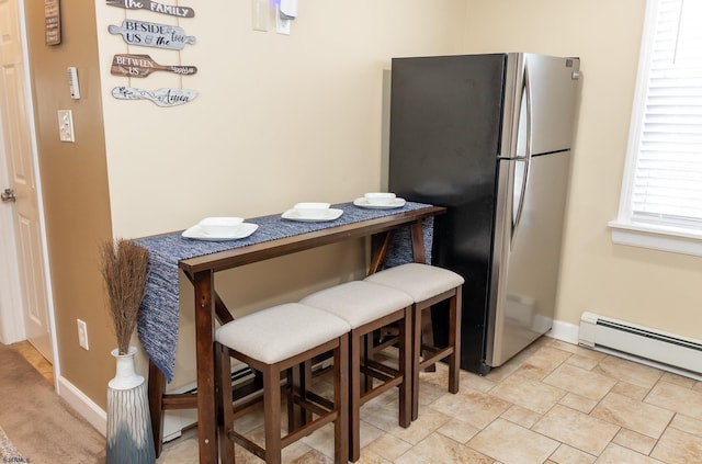 dining space with a baseboard radiator