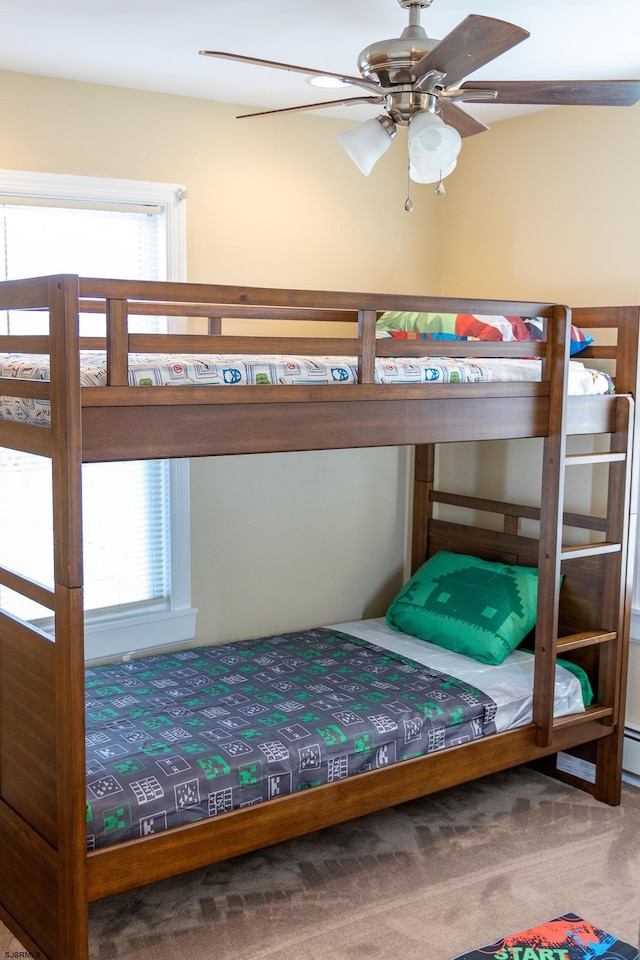 bedroom featuring multiple windows, carpet floors, and ceiling fan