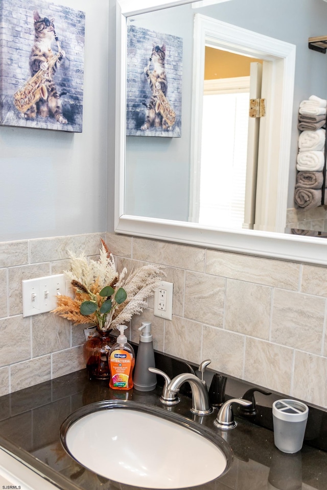 bathroom featuring sink and backsplash