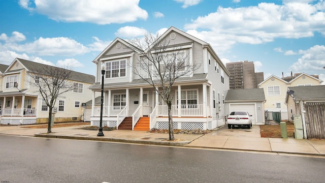 view of front of home featuring a garage, an outdoor structure, and a porch