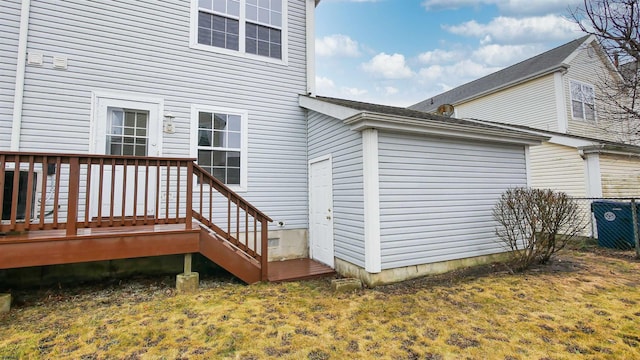 exterior space with a wooden deck and a lawn