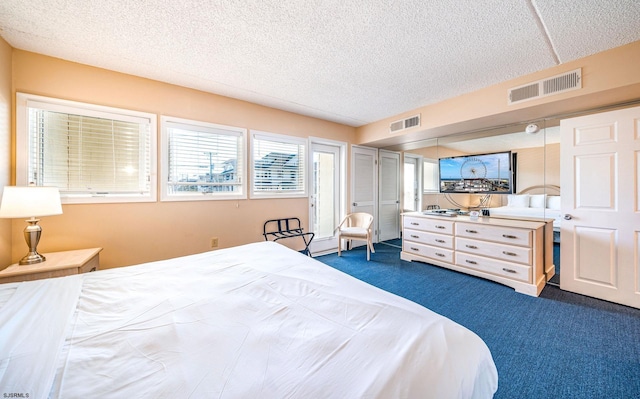 carpeted bedroom with a textured ceiling