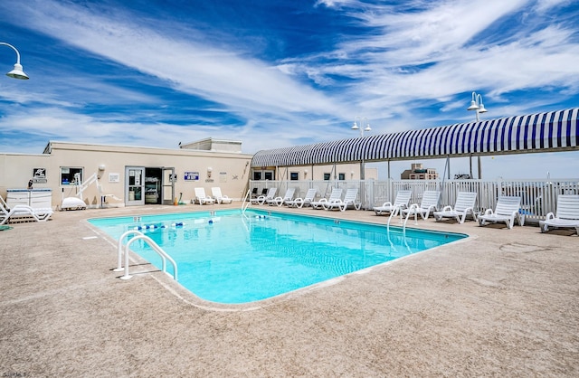 view of swimming pool with a patio