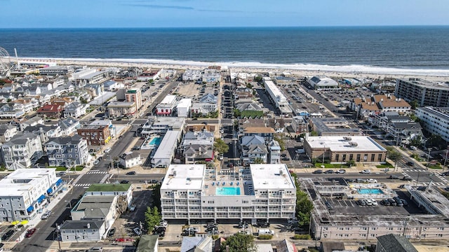 birds eye view of property featuring a water view and a view of the beach