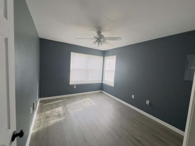 spare room featuring hardwood / wood-style floors and ceiling fan