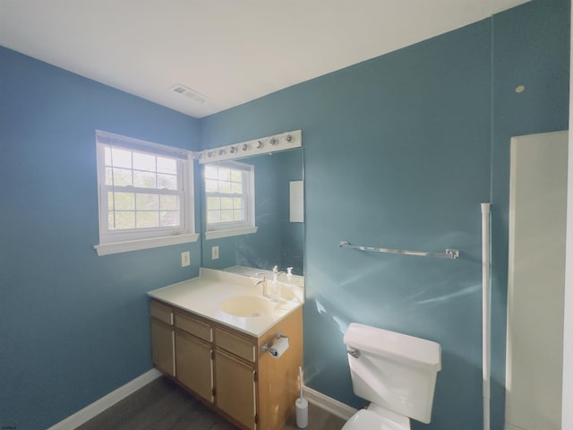 bathroom featuring vanity and toilet