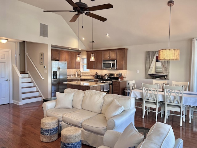 living room featuring ceiling fan, sink, dark hardwood / wood-style floors, and high vaulted ceiling