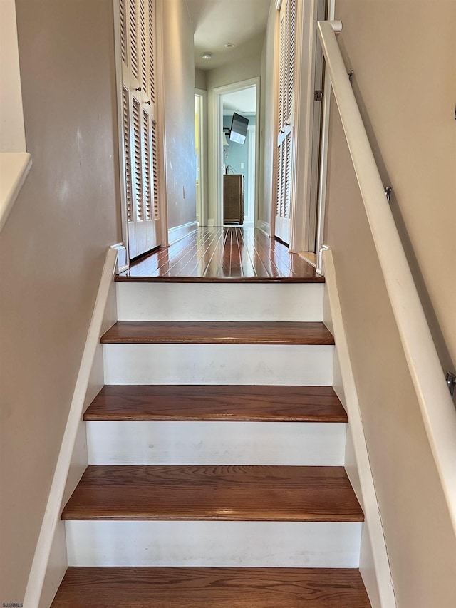 stairs with hardwood / wood-style flooring