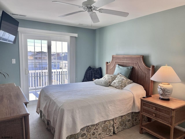 bedroom with access to exterior, ceiling fan, and carpet