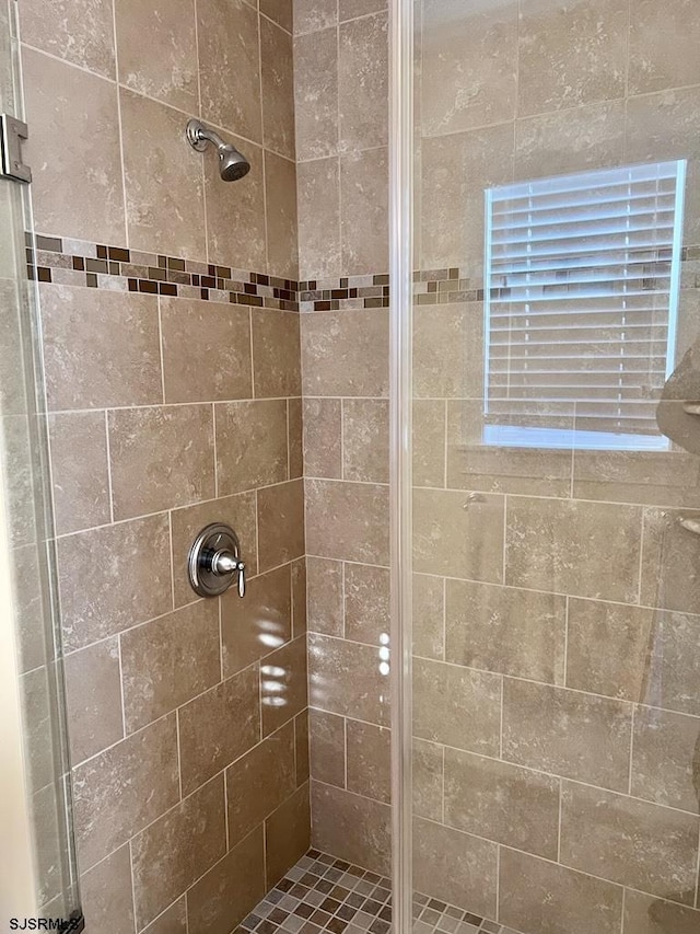 bathroom with tiled shower