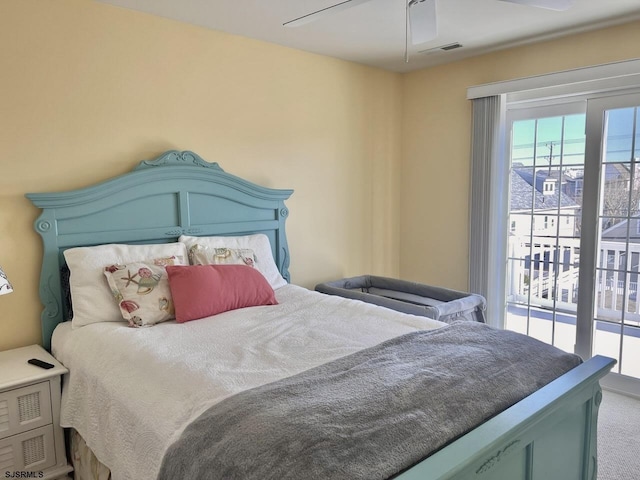 bedroom featuring access to outside, ceiling fan, and carpet