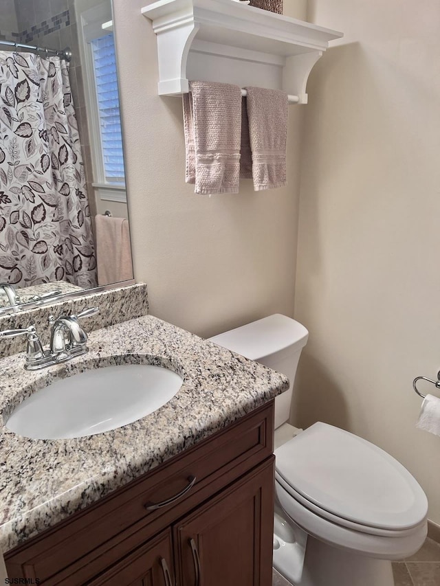 bathroom with vanity, toilet, and a shower with shower curtain