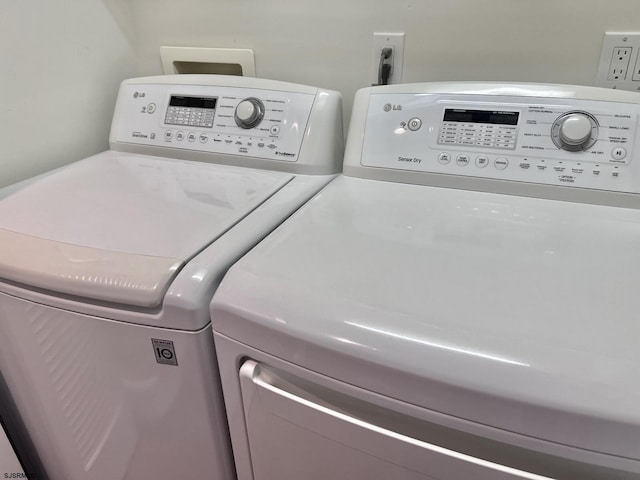 clothes washing area featuring separate washer and dryer