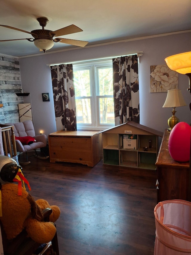 sitting room with crown molding, dark hardwood / wood-style floors, and ceiling fan